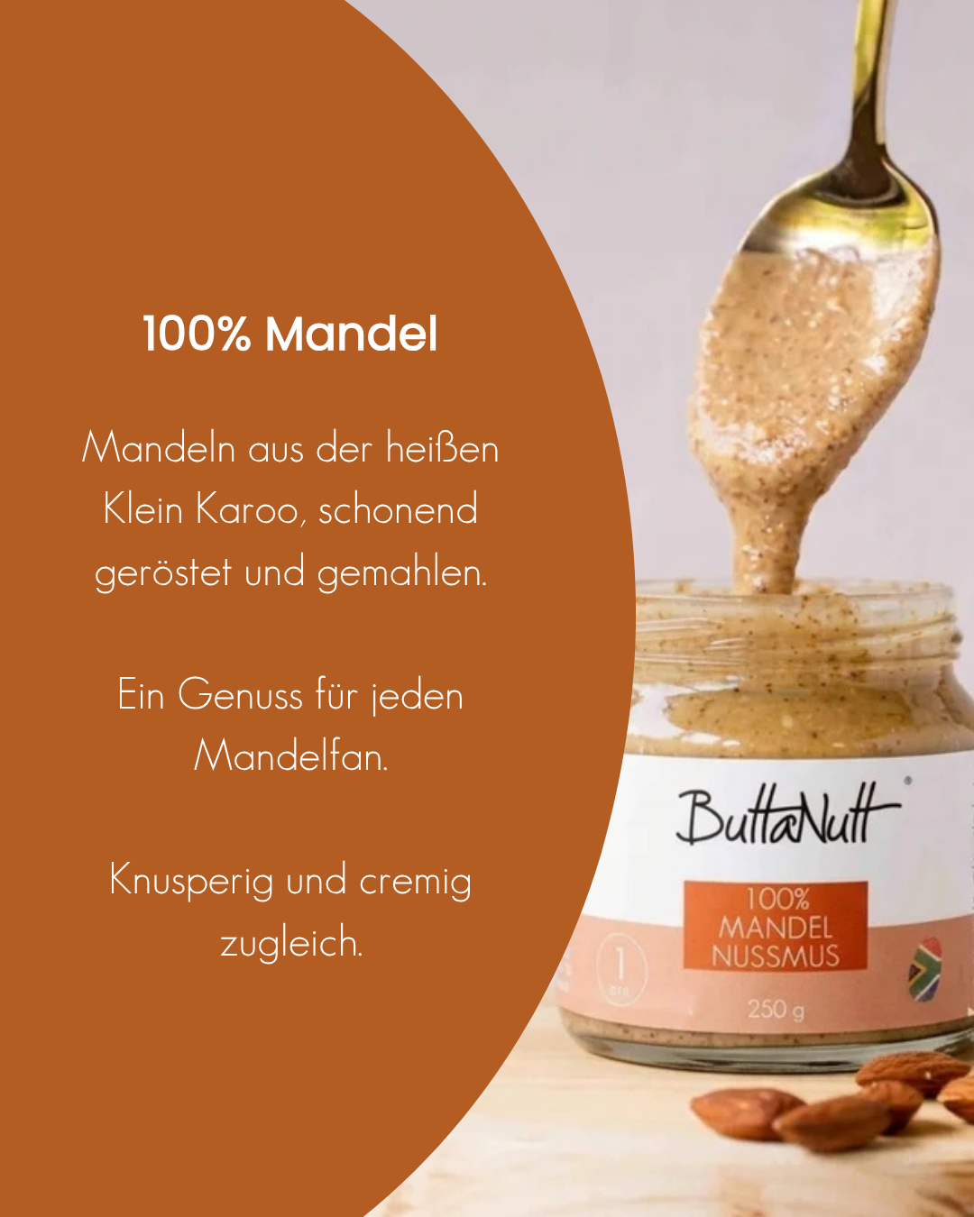 Löffel mit cremigem 100 % Mandel Nussmus von ButtaNutt über dem offenen 250-g-Glas